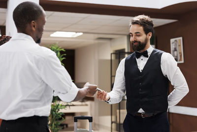 Side view of couple standing in office