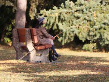 Woman sitting on park bench