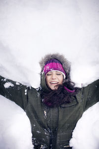 Young woman lying in snow