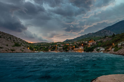 Scenic view of sea by buildings against sky