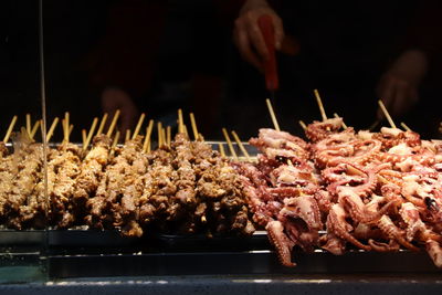 Close-up of hands on barbecue grill