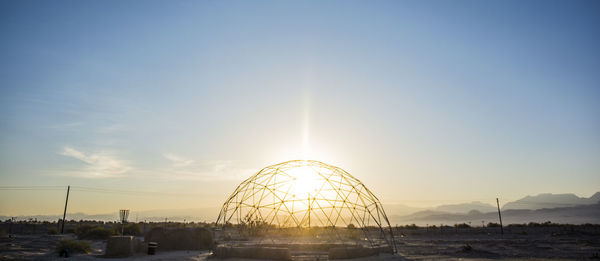 Ferris wheel against sky during sunset