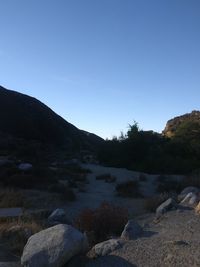 Scenic view of rocky mountains against clear blue sky