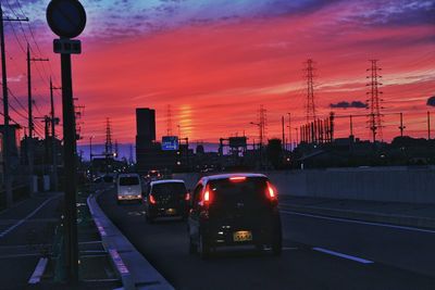 Cars on road at sunset