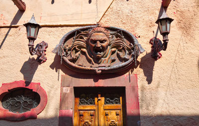 Low angle view of statue against building