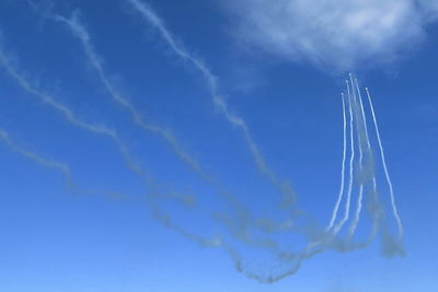 Low angle view of vapor trails in sky