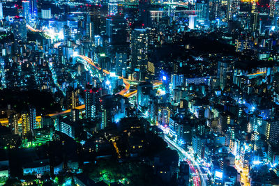 High angle view of illuminated city buildings at night