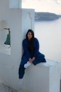 Portrait of young woman sitting outdoors