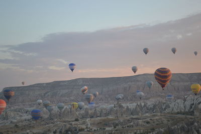 Low angle view of hot air balloons flying in sky