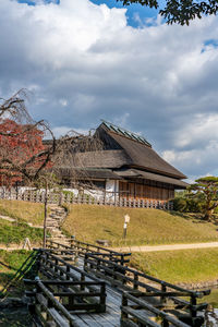 House by trees against sky
