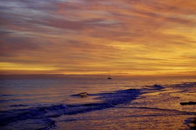 Scenic view of sea against orange sky