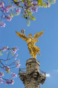 Low angle view of statue against blue sky