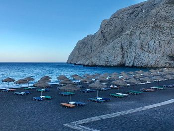 Scenic view of beach against clear blue sky