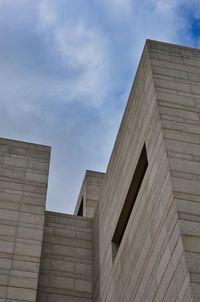 Low angle view of building against cloudy sky