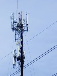 Low angle view of electricity pylon against sky
