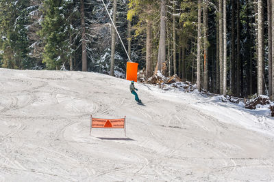 Person skiing on snow covered landscape during winter