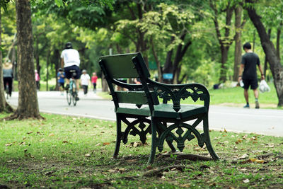 Rear view of empty bench in park