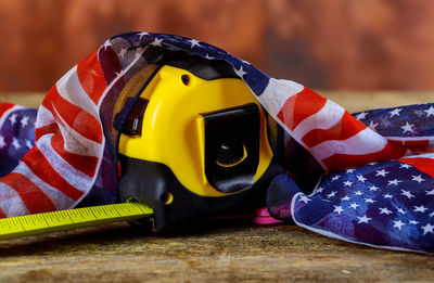 Close-up of retractable tape measure covered by american flag tablecloth