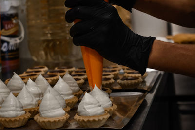 Cropped hand of person preparing food