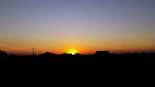 Silhouette landscape against sky during sunset