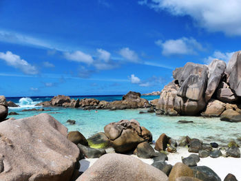 Rocks on beach against sky