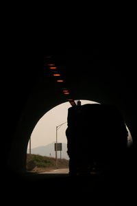 Silhouette man seen through car window