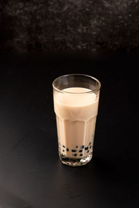 Close-up of drink on table against black background