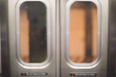 Close-up of glass doors in train