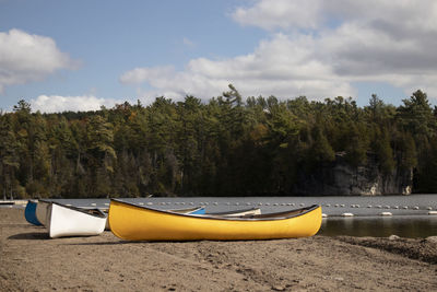 Boats moored on shore against the sky.