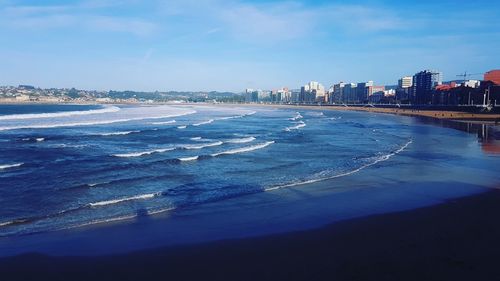 Scenic view of sea and buildings against sky