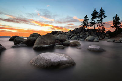 Scenic view of rocks against sky during sunset