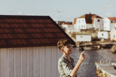 Portrait of man standing against building