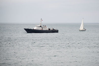 Sailboat sailing on sea against sky