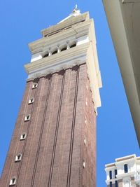 Low angle view of building against clear blue sky