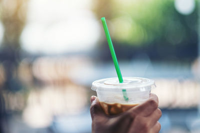 Close-up of hand holding coffee cup