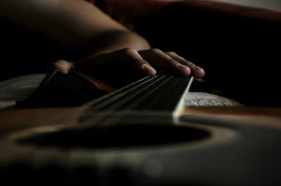 Close-up of hands playing guitar