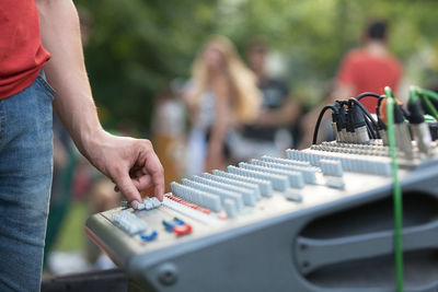 Cropped image of man adjusting sound mixer