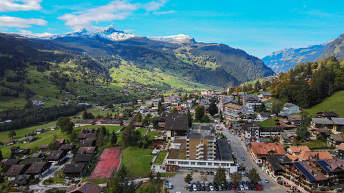 High angle view of townscape and mountains against sky