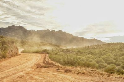 Dirt road against mountains