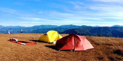 Scenic view of tent on mountain against sky