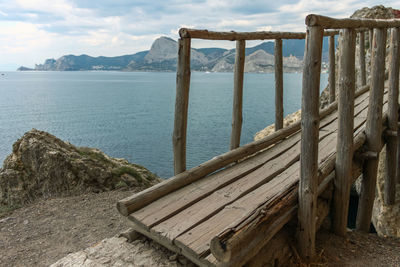 Wooden posts on beach against sky