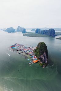 Aerial view of rock formations in river against sky