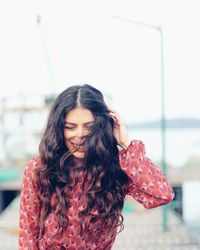 Portrait of a smiling young woman standing outdoors