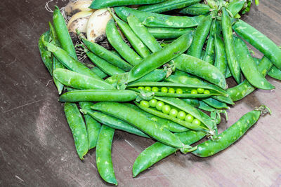 High angle view of green chili peppers on table