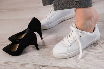 Low section of woman standing on hardwood floor