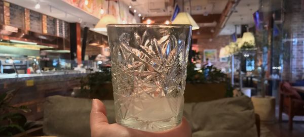 Midsection of person holding ice cream in glass