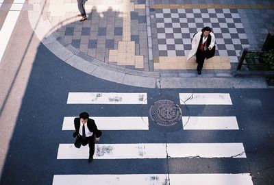 High angle view of people walking on road