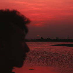 Silhouette man on beach during sunset