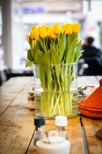 Yellow tulips in vase on table