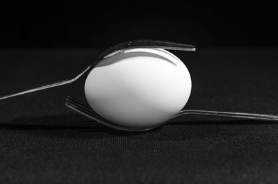 Close-up of crystal ball on table against black background